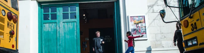 A kid walking into 24th Street Theatre